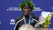 Kenya's Evans Chebet, winner of the Men's Division, stands for photos after completing the 2022 New York City Marathon in New York on November 6, 2022. (Photo by TIMOTHY A. CLARY / AFP) (Photo by TIMOTHY A. CLARY/AFP via Getty Images)
