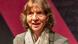 Aleida Assmann looks into the camera wearing a scarf and blazer