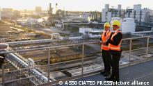 German Chancellor Olaf Scholz, left, is and the CEO of BASF, Martin Brudermueller, right, talk as they visit the BASF company in Schwarzheide south of Berlin, Germany, Tuesday, Nov. 1, 2022. (Lisi Niesner/Pool Photo via AP)