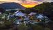 A Japanese temple set in the mountains with a sunset A Japanese temple set in the mountains with a sunset