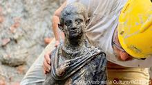 A worker holds a 2,300-year-old bronze statue which has been discovered in San Casciano dei Bagni, Italy, in this handout photo obtained by Reuters on November 8, 2022. Ministero della Cultura/Handout via REUTERS ATTENTION EDITORS THIS IMAGE HAS BEEN SUPPLIED BY A THIRD PARTY. NO ARCHIVES. NO RESALES
