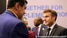 Handout picture released by the Venezuelan Presidency showing Venezuela's President Nicolas Maduro (L) talking with French President Emmanuel Macron during the COP27 climate conference at the Sharm el-Sheikh International Convention Centre, in Egypt's Red Sea resort city of the same name, on November 7, 2022. (Photo by Handout / Venezuelan Presidency / AFP) / RESTRICTED TO EDITORIAL USE - MANDATORY CREDIT AFP PHOTO / VENEZUELAN PRESIDENCY - NO MARKETING - NO ADVERTISING CAMPAIGNS - DISTRIBUTED AS A SERVICE TO CLIENTS