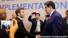 Handout picture released by the Venezuelan Presidency showing Venezuela's President Nicolas Maduro (R) shaking hands with French President Emmanuel Macron during the COP27 climate conference at the Sharm el-Sheikh International Convention Centre, in Egypt's Red Sea resort city of the same name, on November 7, 2022. (Photo by Handout / Venezuelan Presidency / AFP) / RESTRICTED TO EDITORIAL USE - MANDATORY CREDIT AFP PHOTO / VENEZUELAN PRESIDENCY - NO MARKETING - NO ADVERTISING CAMPAIGNS - DISTRIBUTED AS A SERVICE TO CLIENTS