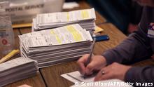MILWAUKEE, WISCONSIN - NOVEMBER 08: Workers count mail-in and in-person absentee ballots at the Wisconsin Center on November 08, 2022 in Milwaukee, Wisconsin. After months of candidates campaigning, Americans are voting in the midterm elections to decide close races across the nation. Scott Olson/Getty Images/AFP