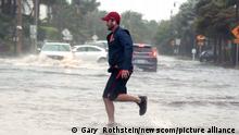 Tropical Storm Nicole Nears Hurricane Strength as a man jogs through the flooded roads in the Palm Beach area..Hurricane conditions are expected for the east coast of Florida as Tropical Storm Nicole gathers strength on then coast of Palm Beach, Florida, Wednesday, November 9, 2022. Photo by Gary I Rothstein / UPI picture alliance