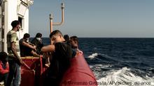 Some of the migrants rescued from the sea are seen on board of the humanitarian ship Ocean Viking cruising in the Mediterranean Sea, Wednesday, Nov. 9, 2022. The SOS Mediterranee humanitarian group said the Norwegian-flagged ship is heading toward the French island of Corsica in hopes that France will offer its 234 passengers a safe port, after Italy backed down and allowed migrants from three other rescue ships to disembark on Italian soil. (AP Photo/Vincenzo Circosta)