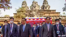 China’s Prime Minister Li Keqiang (centre L) and Cambodia's Urban Planning and Construction Chea Sophara (centre R) walk during a handover ceremony following the completion of a China-assisted restoration project of the Ta Keo temple at the Angkor complex in Siem Reap province on November 10, 2022.
Khut Sao / AFP