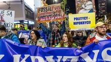Protesters take part in the 'Crisis Strike', a demonstration against the passivity of the Polish government in the face of the challenges related to the war in neighbouring Ukraine, the energy crisis and the climate crisis in Warsaw, Poland on October 28, 2022. - A few hundred people from various backgrounds - from agricultural unions to youth climate organizations - gathered to protest in the streets. (Photo by Wojtek RADWANSKI / AFP) (Photo by WOJTEK RADWANSKI/AFP via Getty Images)