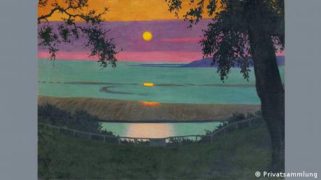 Bild eines Sonnenuntergangs über dem Meer, der Himmel ist rosa, lila und orange, im Vordergrund sind das Ufer und Bäume zu sehen. 