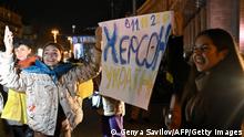 People hold a slogan which reads 11/11/2022 - Kherson - Ukraine as they gather in Maidan Square to celebrate the liberation of Kherson, in Kyiv on November 11, 2022, amid the Russian invasion of Ukraine. - Ukraine's President Volodymyr Zelensky said on November 11 that Kherson was ours after Russia announced the completion of its withdrawal from the regional capital, the only one Moscow captured in nearly nine months of fighting. (Photo by Genya SAVILOV / AFP) (Photo by GENYA SAVILOV/AFP via Getty Images)