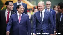 13.11.2022, Vietnam, Hanoi: Bundeskanzler Olaf Scholz (SPD) wird von Pham Minh Chinh (l), Premierminister der Sozialistischen Republik Vietnam, empfangen. Vietnam ist der erste Stop des Bundeskanzlers auf dem Weg zum G20-Gipfel. Foto: Kay Nietfeld/dpa +++ dpa-Bildfunk +++