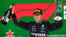 Formula One F1 - Brazilian Grand Prix - Jose Carlos Pace Circuit, Sao Paulo, Brazil - November 13, 2022
Mercedes' George Russell celebrates on the podium with the trophy after winning the race REUTERS/Amanda Perobelli