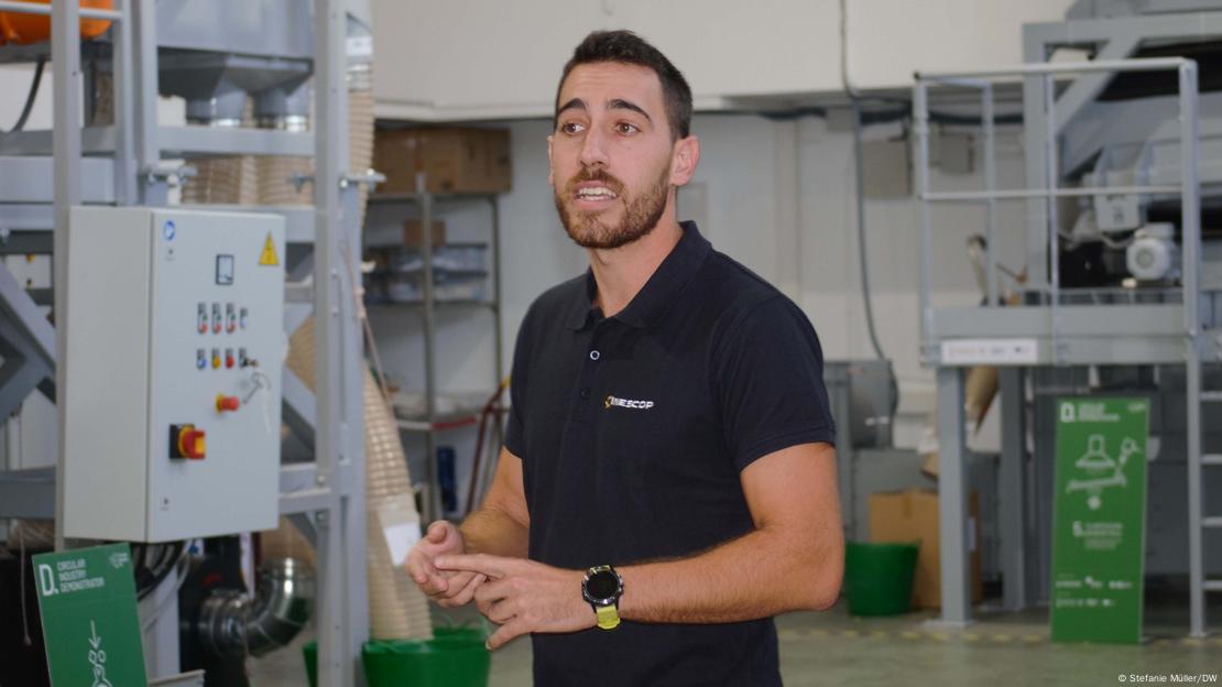 Borja Mateu, in a black T-shirt with a black beard, standing in his recycling factory