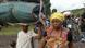 Women walking with children and possessions Women walking with children and possessions