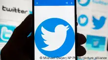 FILE - The Twitter logo is seen on a cell phone, Friday, Oct. 14, 2022, in Boston. The â€œofficialâ€ designation for major corporate accounts on Twitter appeared, vanished, and depending on the account, appeared or vanished again and some companies took to the social media platform to warn of imposters. (AP Photo/Michael Dwyer, File)