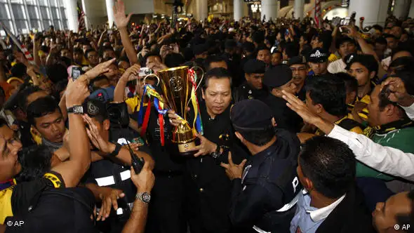 Hundreds of fans crowded the airport in Kuala Lumpur to receive the winning team on Thursday