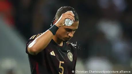 Thilo Kehrer douses his head with water during Germany's international friendly in Oman