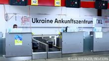 An employee sits on a desk at an accommodation centre for refugees, including Ukrainians, inside former Tegel airport in Berlin, Germany November 9, 2022. REUTERS/Lisi Niesner