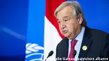 UN Secretary General Antonio Guterres speaks in front of Egyptian and UN flags