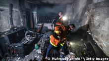 Palestinian firefighters extinguish flames in an apartment ravaged by fire in the Jabalia refugee camp in the northern Gaza strip, on November 17, 2022. - A large fire that ripped through a home north of Gaza City killed at least 21 people, including seven children, official and medical sources said. (Photo by MAHMUD HAMS / AFP) (Photo by MAHMUD HAMS/AFP via Getty Images)