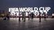 Personas ante un cartel luminoso de la FIFA en Qatar. Personas ante un cartel luminoso de la FIFA en Qatar.