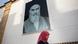 A woman walks past a portrait of Ayatollah Khomeini in Qom A woman walks past a portrait of Ayatollah Khomeini in Qom