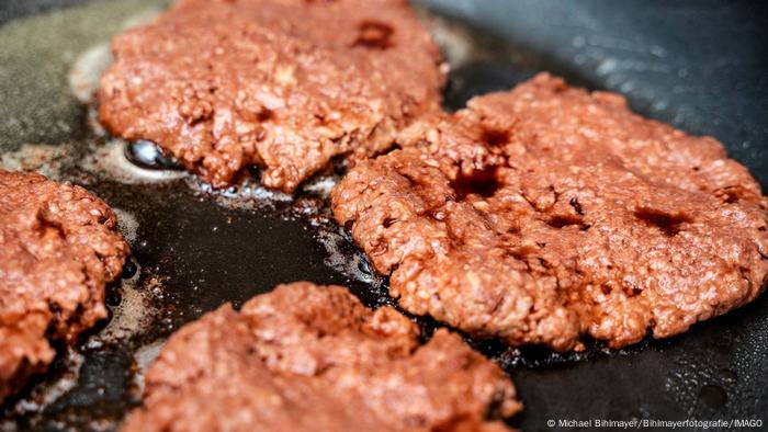 Hamburger without meat: Vegan patties made from pea protein sizzle in a pan Hamburger without meat: Vegan patties made from pea protein sizzle in a pan