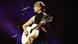 Taylor Swift performs with a guitar Taylor Swift performs with a guitar