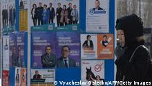 A pedestrian walks past campaign posters of presidential candidates in Astana on November 18, 2022, ahead of Kazakhstan's presidential elections on November 20. - Kazakhstan will hold a snap presidential vote expected to cement incumbent President Kassym-Jomart Tokayev's grip on power, months after deadly unrest shook the Central Asian country and left more than 230 people dead. (Photo by VYACHESLAV OSELEDKO / AFP) (Photo by VYACHESLAV OSELEDKO/AFP via Getty Images)