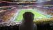 A general view inside the stadium before the match, with a veiled spectator looking on A general view inside the stadium before the match, with a veiled spectator looking on