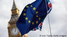 LONDON, ENGLAND - SEPTEMBER 09: A protester waves the European Union and Union Jack flags in front of Big Ben as thousands march to Parliament Square in support of the European Union on September 9, 2017 in London, England. The British government has this week begun debating the European Union Withdrawal Bill as it prepares for Brexit. (Photo by Jack Taylor/Getty Images)