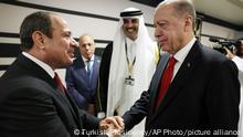 Turkish President Recep Tayyip Erdogan, right, shakes hands with Egypt's President Abdel Fattah el-Sisi during the opening ceremony of the 2022 World Cup in Doha, Qatar, Sunday, Nov. 20, 2022. (Turkish Presidency via AP)