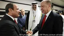 Turkish President Recep Tayyip Erdogan, right, shakes hands with Egypt's President Abdel Fattah el-Sisi during the opening ceremony of the 2022 World Cup in Doha, Qatar, Sunday, Nov. 20, 2022. (Turkish Presidency via AP)