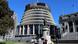 People stand outside the executive wing of the New Zealand Parliament complex People stand outside the executive wing of the New Zealand Parliament complex