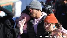 (L-R) Tyler Johnston, his fiance, Keenan Mestas-Holmes, and Altas Pretzeus embrace while paying their repsects at a memorial for the vicitms of the mass shooting at Club Q, an LGBTQ nightclub, in Colorado Springs, Colorado, on November 20, 2022. - At least five people were killed and 18 wounded in a mass shooting at an LGBTQ nightclub in the US city of Colorado Springs, police said on November 20, 2022. (Photo by Jason Connolly / AFP) / ìThe erroneous mention[s] appearing in the metadata of this photo by Jason Connolly has been modified in AFP systems in the following manner: [Keenan Mestas-Holmes] instead of [Keenan Mastes-Holmes]. Please immediately remove the erroneous mention[s] from all your online services and delete it (them) from your servers. If you have been authorized by AFP to distribute it (them) to third parties, please ensure that the same actions are carried out by them. Failure to promptly comply with these instructions will entail liability on your part for any continued or post notification usage. Therefore we thank you very much for all your attention and prompt action. We are sorry for the inconvenience this notification may cause and remain at your disposal for any further information you may require.î