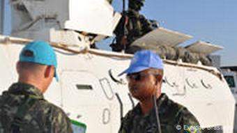 Zwei Soldaten der UNO-Mission vor einem weißen UN-Panzer in Port-au-Prince (Foto: AP)