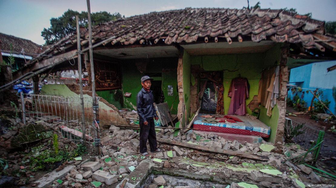 A local stands in front of his house, damaged after earthquake hit in Cianjur, West Java province, Indonesia
