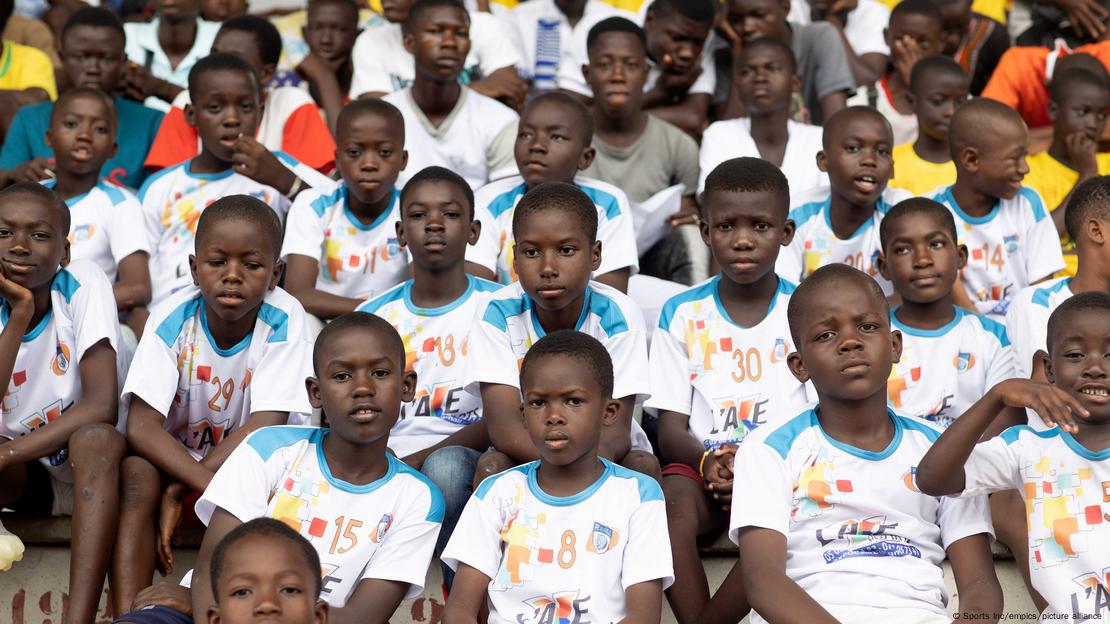 A group of school kids from Niger, wearing football jerseys.