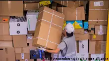 Ein Mitarbeiter räumt in einem Deutsche Post DHL Paketzentrum Pakete in einen Lkw.