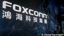 FILE - The Foxconn logo is seen during the Hon Hai Tech Day at the Nangang Exhibition Center in Taipei, Taiwan, on Oct. 18, 2022. Employees at the world's biggest Apple iPhone factory have been beaten and detained in protests over contract disputes amid anti-virus controls, according to employees and videos posted on social media Wednesday, Nov. 23, 2022. Videos that said they were filmed at the factory in the central city of Zhengzhou, China, showed thousands of people in masks facing police in white protective suits with riot shields. (AP Photo/Chiang Ying-ying, File)