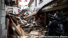 DUZCE, TURKIYE - NOVEMBER 23: A press officer takes a photo of the settlement's debris after a 5.9-magnitude earthquake jolted the western Turkish province of Duzce on November 23, 2022. Muhammed Enes Yildirim / Anadolu Agency