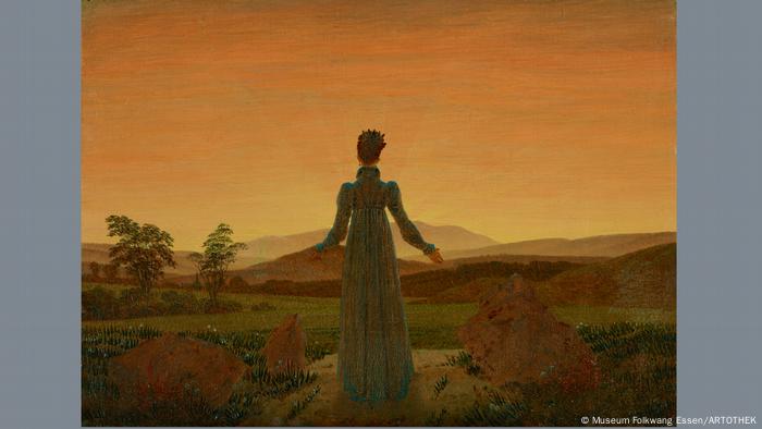 This work by Caspar David Friedrich shows a woman in a long dress in front of the setting sun.