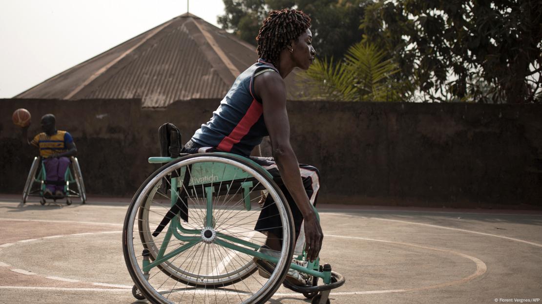  A wheelchair basketball player warms up on a basketball court,