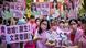 Campaigners in Taipei hold pink signs Campaigners in Taipei hold pink signs