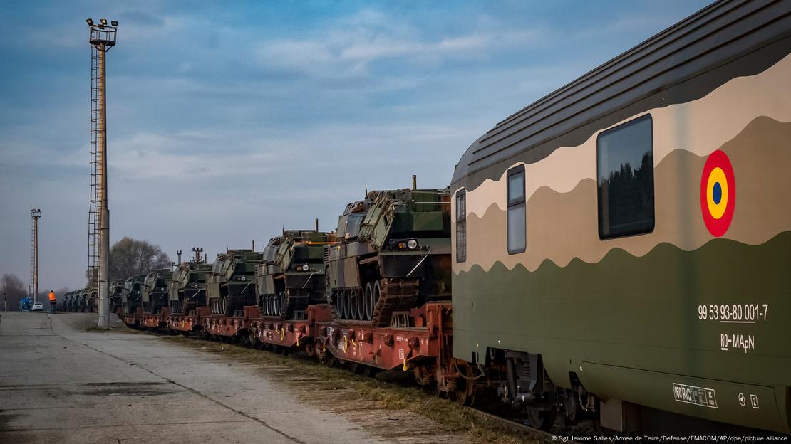 Battle tanks lined up on railway waggons
