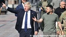 Ukrainian President Volodymyr Zelensky (R) and British Prime Minister Boris Johnson (L) walk at the Ally of Bravery on Ukraine's Independence Day on August 24, 2022, amid Russia's invasion of Ukraine. - British Prime Minister Boris Johnson was in Kyiv on August 24, 2022, hailing the strong will of Ukrainians to resist Russia's invasion, as the nation celebrates its Independence Day and marks the milestone of six months of war. (Photo by Genya SAVILOV / AFP) (Photo by GENYA SAVILOV/AFP via Getty Images)