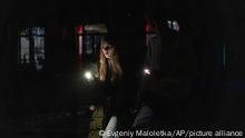 A young couple walk at the city center which lost electrical power after yesterday's Russian rocket attack in Kyiv, Ukraine, Thursday, Nov. 24, 2022. (AP Photo/Evgeniy Maloletka)