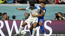 AL KHOR, QATAR - NOVEMBER 25: Raheem Sterling of England controls the ball under pressure of Tyler Adams of United States during the FIFA World Cup Qatar 2022 Group B match between England and USA at Al Bayt Stadium on November 25, 2022 in Al Khor, Qatar. (Photo by Clive Mason/Getty Images)
