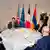 Leaders of Azerbaijan and Armenia sit at a round table with the president of France during talks in Prague