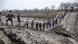 Locals help transfer humanitarian aid across a collapsed bridge near Novopetrivka, following the withdrawal of Russian troops from Kherson region Locals help transfer humanitarian aid across a collapsed bridge near Novopetrivka, following the withdrawal of Russian troops from Kherson region